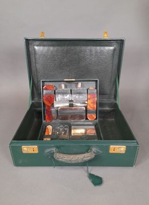 a green suitcase with a bunch of items inside of it