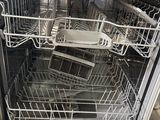silver dishwasher in a kitchen with a lot of dishes inside of it
