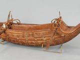 a wooden boat that is on display on a table