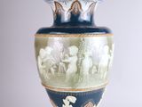 a blue vase with a picture of a man and a woman on it
