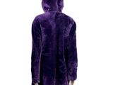 the back view of a person wearing a purple coat and black boots