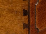 a close up of a drawer with a wooden handle on it