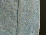 a close up of a blue jacket with a button on it