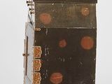 a small wooden box that has dots on it