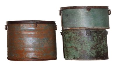 two old metal buckets sitting next to each other on a white surface