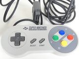 a video game controller sitting next to a game controller