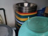 many bowls and pans sitting on the counter