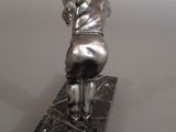 statue of a baseball player on a marble base on a gray background