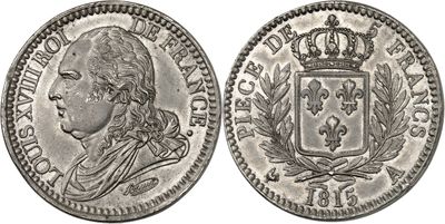 a silver coin with a crown on top of it