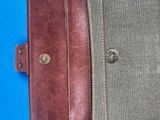 a close up of a brown leather case on a blue surface