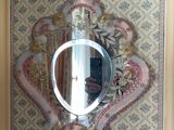 a mirror hanging on the wall above a sink