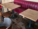 two tables and a bench in a restaurant