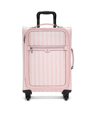 an image of a pink suitcase on wheels on a white background