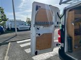 a white van with the door open in the parking lot