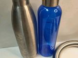 a blue bottle and a silver bottle on a table