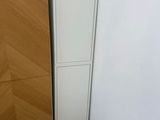 une grande armoire blanche dans un coin de la pièce