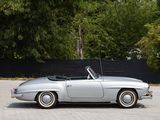 a silver car parked in a parking lot with trees in the background