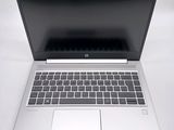a laptop that is open on a white surface