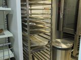 an image of a commercial kitchen with a rack full of food
