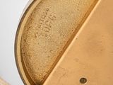 a close up of a metal object on a white surface