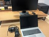 a desk with a laptop and a monitor on it