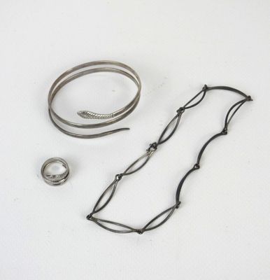 two bracelets and a ring on a white surface