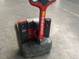 a picture of a red and black machine in a warehouse