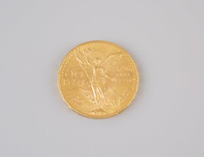 a gold coin with an angel on it on a white surface