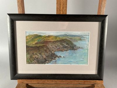 painting on easel of a painting of a view of the ocean