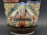 two vases that have been decorated with colorful designs