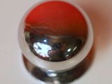 a close up of a red and white object on a white surface