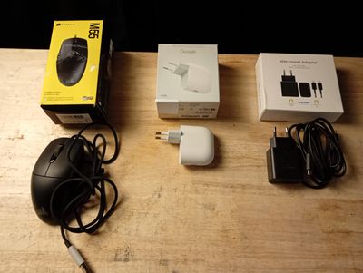 a computer mouse and other electronics sitting on a table