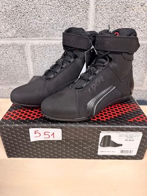 a close up of a pair of motorcycle shoes on a box