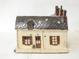a figurine of a house with a tiled roof
