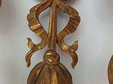 three gold metal wall sconces with flowers and leaves on them