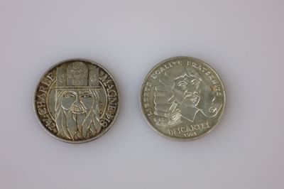une image représentant deux pièces de monnaie posées sur une surface blanche, sur fond blanc
