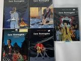 six books of comics are sitting on a white surface