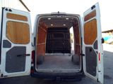 a white van with its doors open in a parking lot