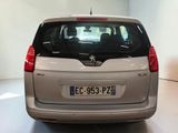 a small silver car that is parked in a room
