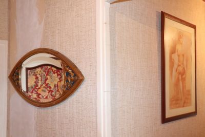 a picture of a bathroom with a mirror on the wall