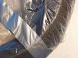 a tire wrapped in plastic with a tape on the side