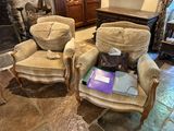 two chairs that are sitting next to each other in a room