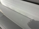 a close up of a car door handle with a shadow on it