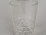 a clear glass cup with water in it on a white surface