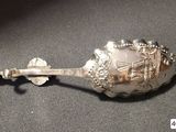 a silver spoon with a silver handle on a table