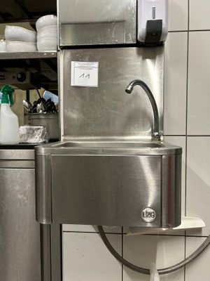 a stainless steel sink in the middle of a kitchen