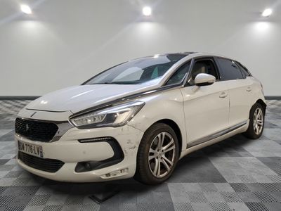 the white car is parked on a checkered floor in a room