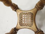 a close up of a wooden chair with a basket on the back