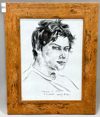 portrait of a young man in a wood frame with a white background