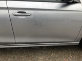 a silver car parked on the side of the road